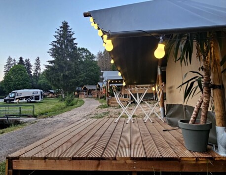 Safaritenten in de avond met lampjes aan de tent