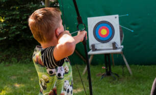 young child engaged in archery.