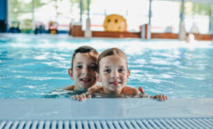 Indoor swimming pool children swimming Camping de Rammelbeek