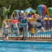Kinderen springen in zwembad Camping Goorzicht springkussen op achtergrond